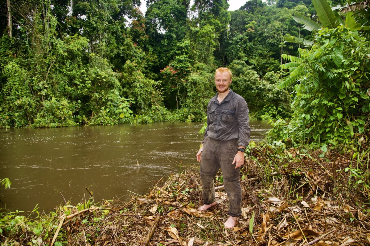 Harrison Carter standing by a river in Guyana